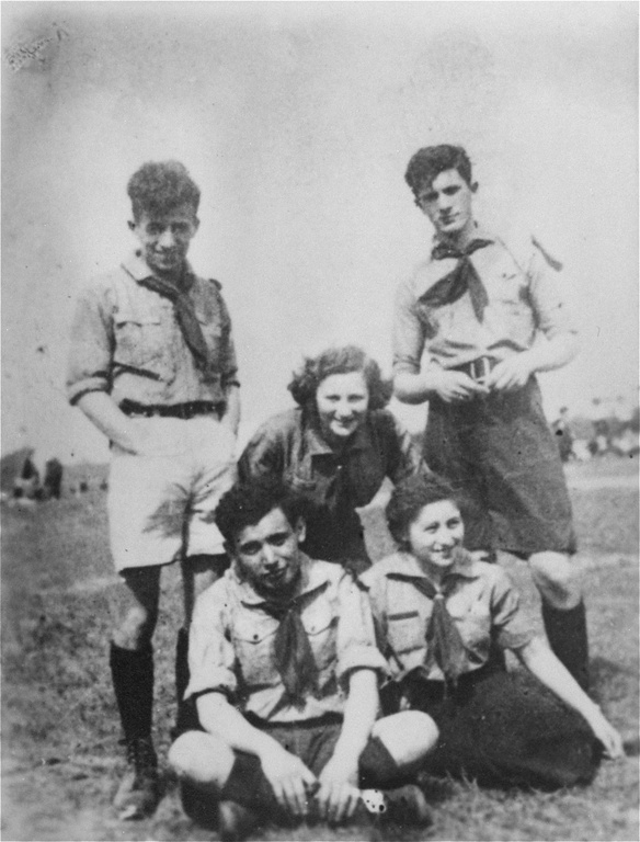 Group portrait of members of Ha-Shomer Ha-Tzair. In the back row, from left to right, are: Zvi Braun, Shifra Sokolka, and Mordechai Anielewicz. In the front, seated, are Moshe Domb and Rachel Zilberberg (“Sarenka”). Warsaw, Poland, 1938.